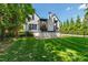 A lawn-level view of the back of a two-story home with a deck, patio, and well-kept lawn at 523 Vick Ave, Raleigh, NC 27612