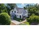 Stately two-story home boasts pristine white siding, blue accents, and lush landscaping, offering curb appeal at 523 Vick Ave, Raleigh, NC 27612