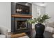 Close-up of living room fireplace with hardwood floors, black mantel, and elegant decor at 523 Vick Ave, Raleigh, NC 27612