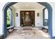 Inviting front porch with stone flooring, wooden benches, craftsman columns, and a stylish wooden door at 523 Vick Ave, Raleigh, NC 27612