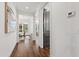 Hallway featuring hardwood floors and views into the dining and living areas, showcasing the open floor plan at 523 Vick Ave, Raleigh, NC 27612