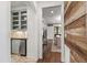 Hallway showcasing wood accents, leading to a dining area and a wet bar with sleek stainless steel appliances at 523 Vick Ave, Raleigh, NC 27612
