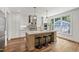 Well-designed kitchen with a large island, stainless steel appliances, granite countertops, and modern lighting fixtures at 523 Vick Ave, Raleigh, NC 27612