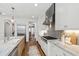Well-equipped kitchen featuring modern appliances, granite countertops, a gas range, and hardwood floors at 523 Vick Ave, Raleigh, NC 27612