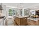 Gourmet kitchen features a spacious island with seating, stainless steel appliances, and beautiful countertops at 523 Vick Ave, Raleigh, NC 27612