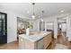 Spacious kitchen with granite countertops, stainless steel appliances, and an island with views into the dining room at 523 Vick Ave, Raleigh, NC 27612