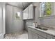 Neutral laundry room with granite countertops and stylish cabinets at 523 Vick Ave, Raleigh, NC 27612