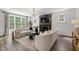 Modern living room with hardwood floors, fireplace, and elegant sofas in a bright and airy space at 523 Vick Ave, Raleigh, NC 27612