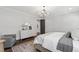 Bright main bedroom featuring a dresser, cozy armchair, and hardwood floors with an area rug at 523 Vick Ave, Raleigh, NC 27612