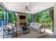 Covered outdoor living area with stone fireplace and comfortable seating at 523 Vick Ave, Raleigh, NC 27612