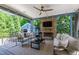 Covered outdoor living area with stone fireplace and comfortable seating at 523 Vick Ave, Raleigh, NC 27612