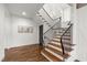 Inviting staircase with wooden steps, iron railing, and natural light enhancing the entry foyer at 523 Vick Ave, Raleigh, NC 27612