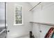 Bright walk-in closet with built-in shelving, hanging rods, and a window providing natural light at 523 Vick Ave, Raleigh, NC 27612