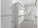 Spacious walk-in closet featuring a window, built-in shelves and hanging rods at 523 Vick Ave, Raleigh, NC 27612
