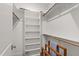 Well-organized walk-in closet with ample shelving and wooden rods for convenient storage at 523 Vick Ave, Raleigh, NC 27612