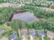 Aerial view of a neighborhood with a pond surrounded by trees at 533 Duchart Ln, Fuquay Varina, NC 27526