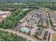 Aerial view of neighborhood featuring a community pool and lake at 533 Duchart Ln, Fuquay Varina, NC 27526