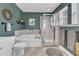 Bathroom showcasing a soaking tub, separate shower, and decorative accents at 533 Duchart Ln, Fuquay Varina, NC 27526