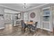 Charming dining area featuring hardwood floors, modern light fixture, and a view into the kitchen at 533 Duchart Ln, Fuquay Varina, NC 27526