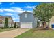 View of blue two-story home featuring attached garage and concrete driveway at 533 Duchart Ln, Fuquay Varina, NC 27526