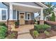 Inviting front porch adorned with decorative plants, seating, and a wreath on the front door at 533 Duchart Ln, Fuquay Varina, NC 27526