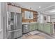 Modern kitchen with stainless steel appliances, granite countertops, and natural wood accent wall at 533 Duchart Ln, Fuquay Varina, NC 27526