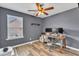 Home office with a wood desk, rolling chair, and a ceiling fan at 533 Duchart Ln, Fuquay Varina, NC 27526