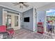 Screened porch with seating, a ceiling fan and a television at 533 Duchart Ln, Fuquay Varina, NC 27526