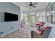 Screened porch with seating, a ceiling fan and a television at 533 Duchart Ln, Fuquay Varina, NC 27526