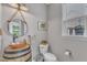 Charming powder room with decorative mirror, unique sink basin, and natural light at 533 Duchart Ln, Fuquay Varina, NC 27526