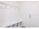 Bright mudroom featuring built-in bench with storage, coat hooks and a white door at 535 Claftin St, Sanford, NC 27330