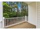 Balcony overlooking a private wooded area with a white wood railing at 5503 Silver Moon Ln, Raleigh, NC 27606