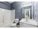 Bathroom featuring dark gray walls, shower, and a vanity with a white sink and cabinets at 5503 Silver Moon Ln, Raleigh, NC 27606