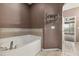 Bathroom featuring a soaking tub and view to an adjacent room at 5503 Silver Moon Ln, Raleigh, NC 27606
