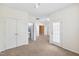 Bedroom with neutral carpet, double closets, a glass paneled door, and an adjacent bathroom at 5503 Silver Moon Ln, Raleigh, NC 27606