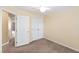Bedroom featuring light yellow walls, carpet, and a double closet at 5503 Silver Moon Ln, Raleigh, NC 27606