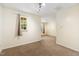 Bedroom with neutral carpet, ample sunlight, and visible opening into an adjacent room at 5503 Silver Moon Ln, Raleigh, NC 27606