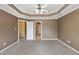 Large bedroom with neutral walls, carpet, and multiple doors leading to other rooms at 5503 Silver Moon Ln, Raleigh, NC 27606