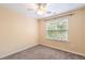 Cozy bedroom featuring light yellow walls, carpet, and a ceiling fan at 5503 Silver Moon Ln, Raleigh, NC 27606