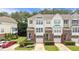 Charming townhomes feature brick and siding exteriors, private garages, and beautifully landscaped front yards at 5503 Silver Moon Ln, Raleigh, NC 27606