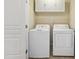 Laundry room features side-by-side washer and dryer under upper cabinets with a wire shelf at 5503 Silver Moon Ln, Raleigh, NC 27606