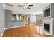 Open-concept living room boasts hardwood floors, a cozy fireplace, and seamless flow to the adjacent kitchen and dining area at 5503 Silver Moon Ln, Raleigh, NC 27606
