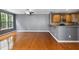 Open living room with hardwood floors, kitchen bar, natural lighting, and neutral color palette for versatile decorating at 5503 Silver Moon Ln, Raleigh, NC 27606