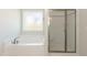Bathroom featuring a soaking tub and a separate glass-enclosed shower at 56 Braddock Ct, Garner, NC 27529