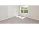 An empty bedroom with plush carpeting, neutral walls, and a double closet at 56 Braddock Ct, Garner, NC 27529