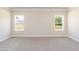 Bright bedroom with two windows offering ample natural light and scenic views at 56 Braddock Ct, Garner, NC 27529