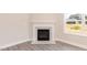 Elegant fireplace with marble surround and gray wood-look flooring at 56 Braddock Ct, Garner, NC 27529