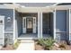 Inviting front entry with stone pillars, sidelights, and well-maintained landscaping at 56 Braddock Ct, Garner, NC 27529