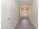 Bright hallway featuring wood-look floors and an elegant entry door at 56 Braddock Ct, Garner, NC 27529