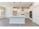 Spacious kitchen with island, stainless steel appliances, white cabinets, and open dining area at 56 Braddock Ct, Garner, NC 27529